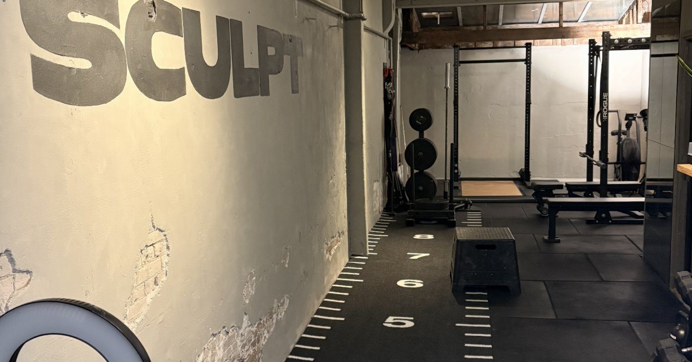 Training area with SCULPT wall logo at SculptClub Amsterdam